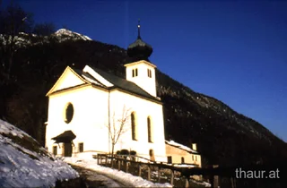 Romedikirchl im Schnee unter blauem Himmel